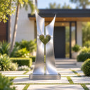 Contemporary brushed stainless steel heart sculpture with architectural lines in a minimalist luxury garden