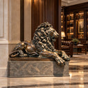 A monumental bronze lion sculpture, resting on a solid granite pedestal, holds an imposing presence for luxury hotel lobbies and architectural interiors.