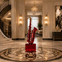Painted stainless steel saxophone sculpture with glossy red finish and contemporary musical instrument art design for luxury spaces
