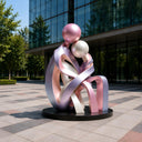 Contemporary stainless steel human sculpture installed in a luxury public plaza environment
