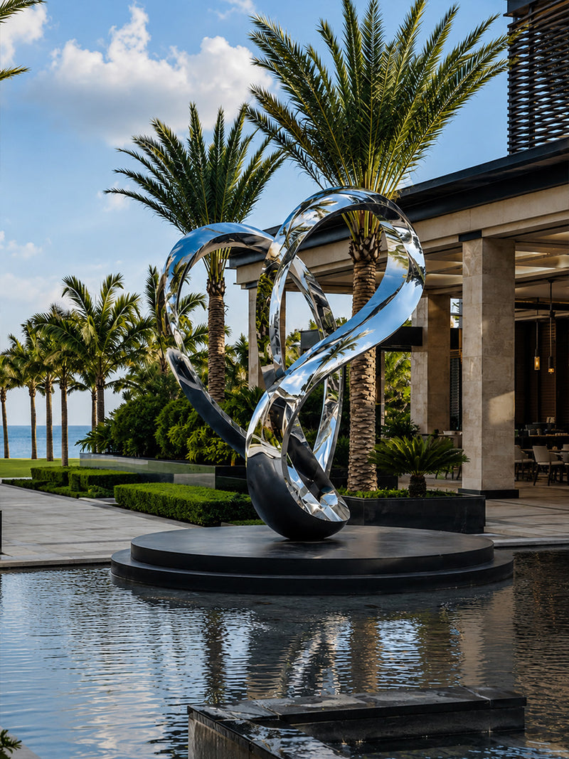 Side view showing the flowing curved design of a contemporary stainless steel sculpture