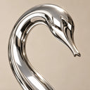 Macro profile of a polished stainless steel swan head and neck, emphasizing the smooth curvature, seamless joints, and reflective metallic surface. Model SS-001.