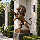 Standing lion statue placed on a garden pathway beside white pillars and greenery, ideal for villa gardens, community entrances, and outdoor landscape decoration.