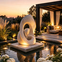 Stone abstract sculpture installed in a modern garden courtyard landscape, creating an artistic focal point for outdoor spaces