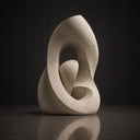 Close-up view of stone abstract sculpture showing organic curves, hollow structure, and travertine-inspired surface texture