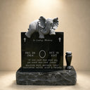 Documented against a dark studio background, this jet-black granite memorial stone showcases a finely carved elephant sculpture and engraved epitaph for custom monument catalogs.