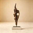 Studio shot of a modern bronze abstract sculpture with a twisted organic form on a stone base against a beige background, highlighting its polished metallic texture for art decor product display and reference.