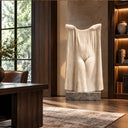 Evoking a surreal silhouette, this white marble drapery sculpture reveals hands emerging from flowing fabric, curated for a luxury executive office.