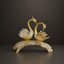 Gold stainless steel swan couple sculpture on black background