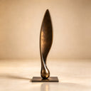 Shot against a neutral studio backdrop, this Eternal Ascent abstract bronze sculpture underscores the uninterrupted twist and elongated vertical plane for design catalogs.