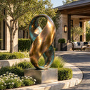 Fashioned from two-tone bronze, this sculpture intertwines into continuous loops, resting atop a concrete base for an outdoor entrance plaza.