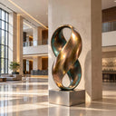 Forged with a dual-toned verdigris and polished bronze finish, this large infinity loop sculpture coils into a continuous abstract form, designed as a statement piece for a luxury hotel lobby.

