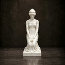 Studio shot of a white marble classical female statue in a draped robe holding flowers on a dark background, highlighting detailed carving and peaceful posture for memorial art product display and reference.