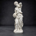 Revealing full-length proportions against a dark studio canvas, this white marble goddess sculpture embodies classical drapery, designed for grand garden environments.