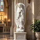 White marble Our Lady of Guadalupe statue MM-025 displayed inside an elegant Catholic church