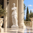 White marble Venus statue on an outdoor terrace with blue sky and cypress trees, suitable for garden, courtyard, and luxury outdoor landscape decoration.